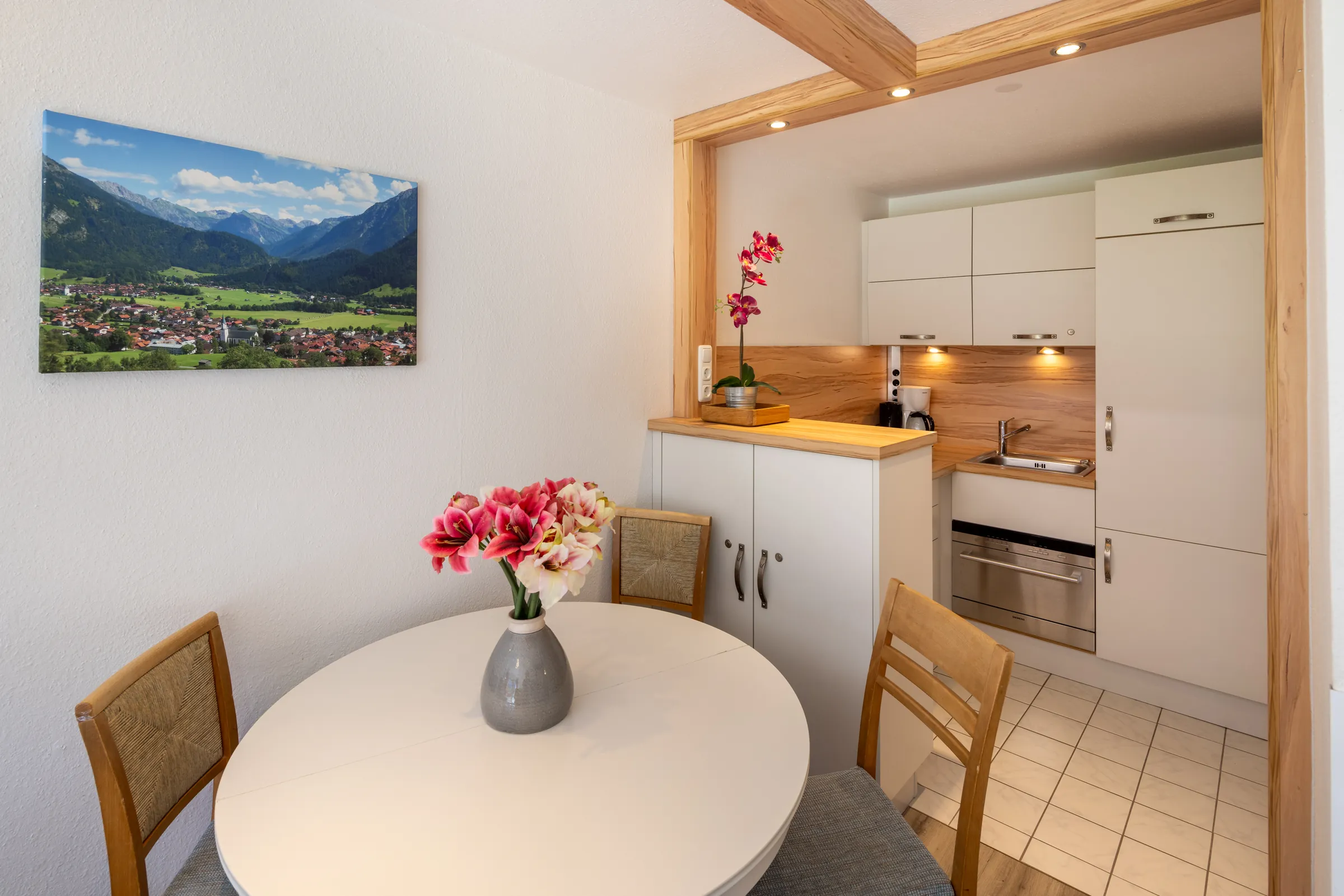 Kitchenette with round dining table in a Premium apartment