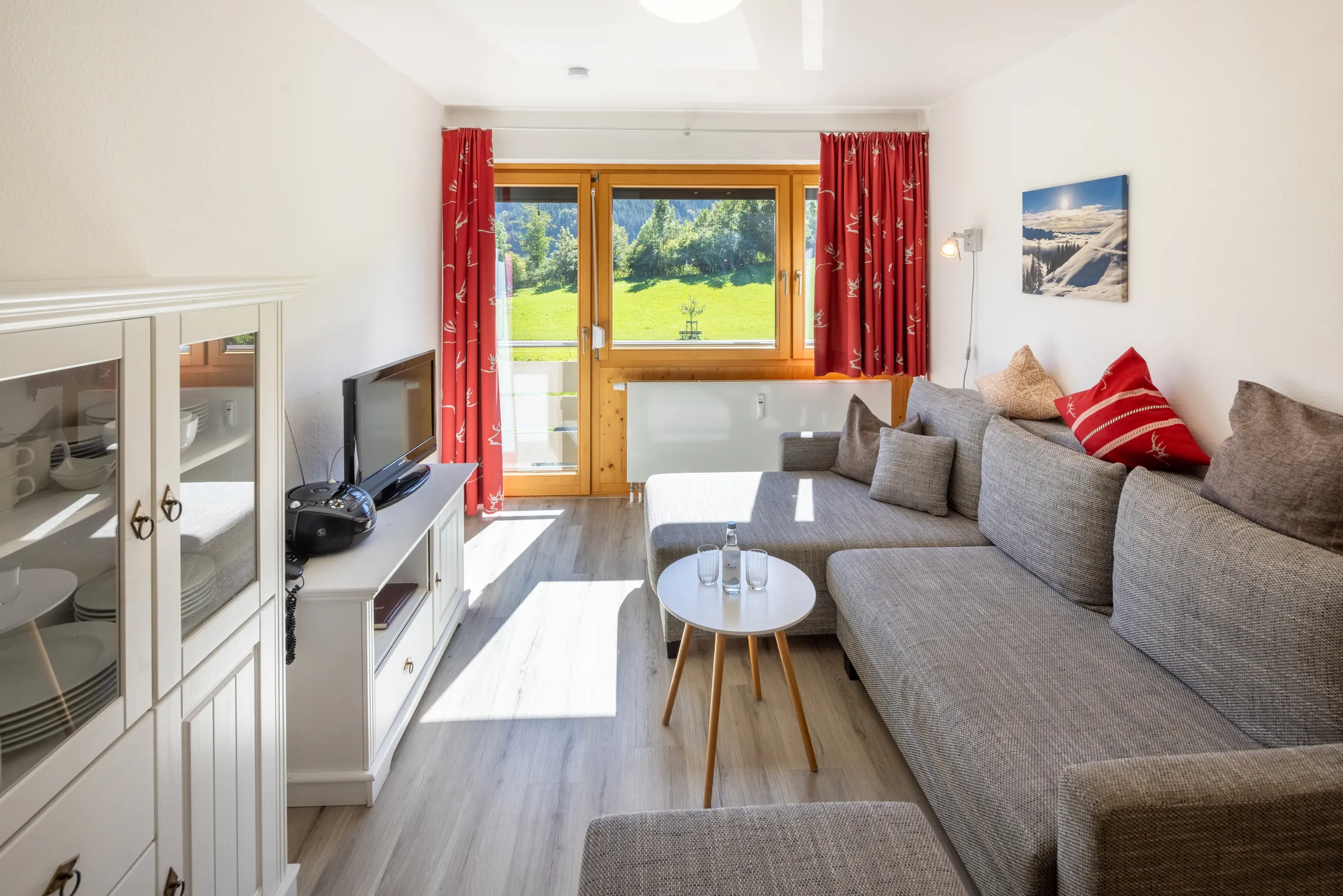 Living room with corner sofa, cabinet and TV in a Premium apartment