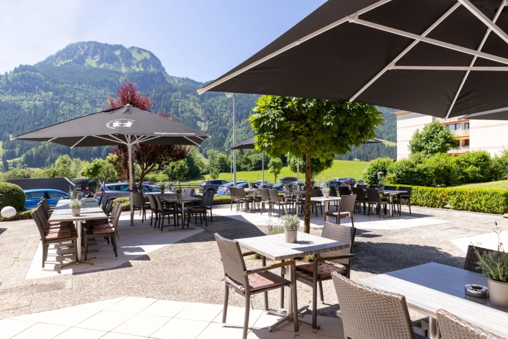 Sonnenterrasse von DIE GAMS mit Sonnenschirmen und Bergblick im Sommer
